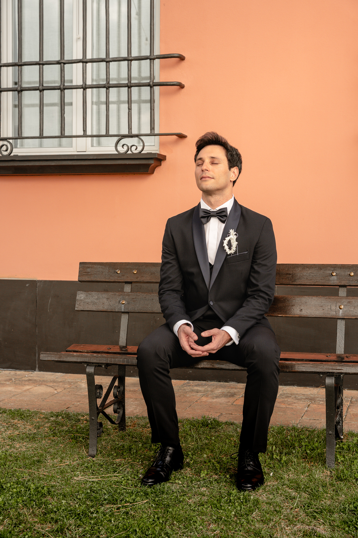 Groom praying during a Christian destination wedding in Italy, emotional faith-based wedding moment