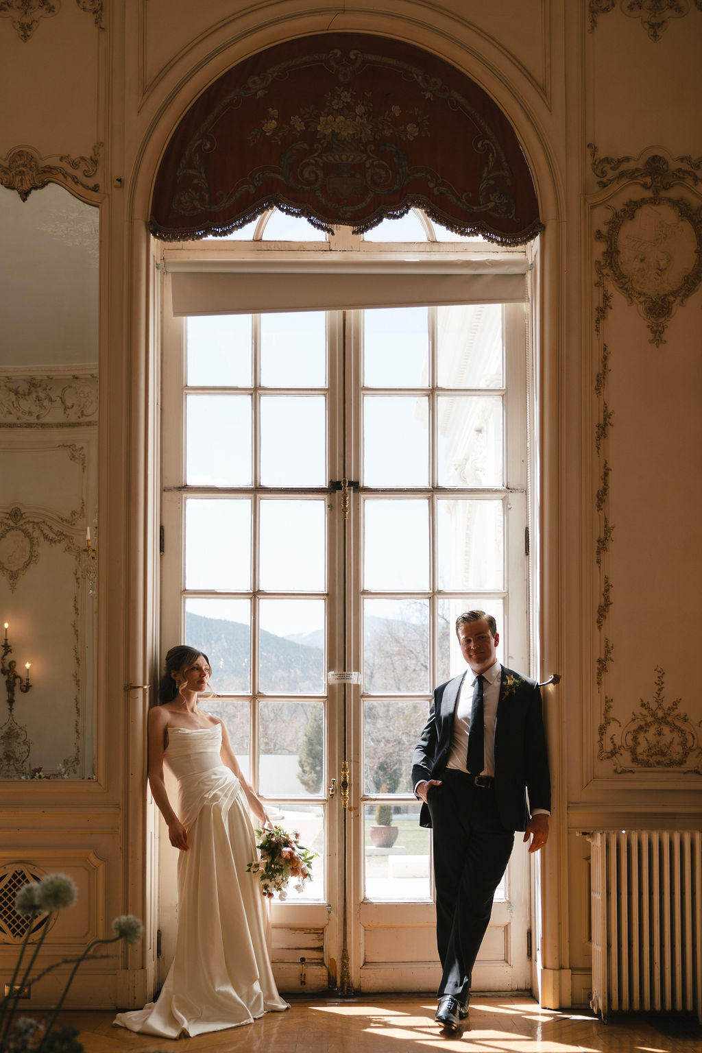 A Christian bride and groom sharing a quiet moment together in an elegant wedding venue before their destination wedding ceremony.